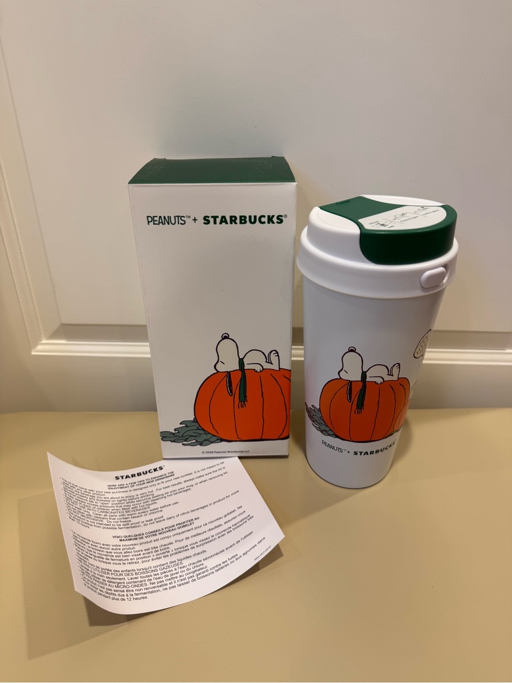 Starbucks White Travel Tumbler with Green Lid and Orange Pumpkin Peanuts Graphic